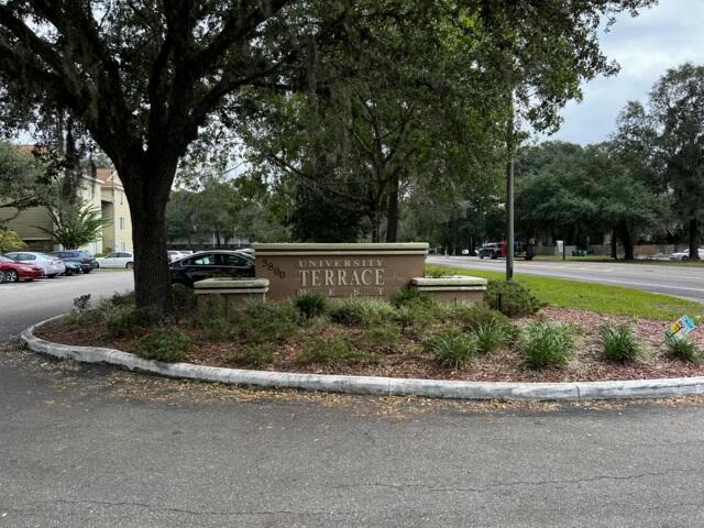 A stone monument sign for University Terrace West stands in a landscaped island with trees — 3800 SW 20th Avenue # 305, Gainesville FL 32607, GAINESVILLE, FL