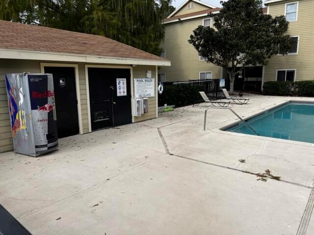 A pool deck features a small utility building with a vending machine and a swimming pool — 3800 SW 20th Avenue # 305, Gainesville FL 32607, GAINESVILLE, FL
