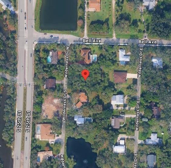 This is an aerial map view of a residential neighborhood with a red location pin — 3602 Wilderness Dr W, Fort Pierce FL 34982, FORT PIERCE, FL
