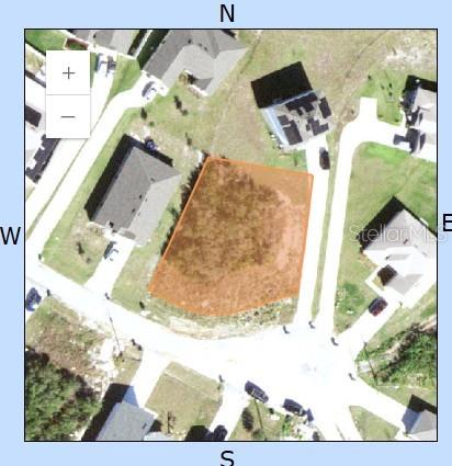 This is an aerial map showing a vacant residential lot highlighted in orange — 17 LARCH LANE, KISSIMMEE, FL
