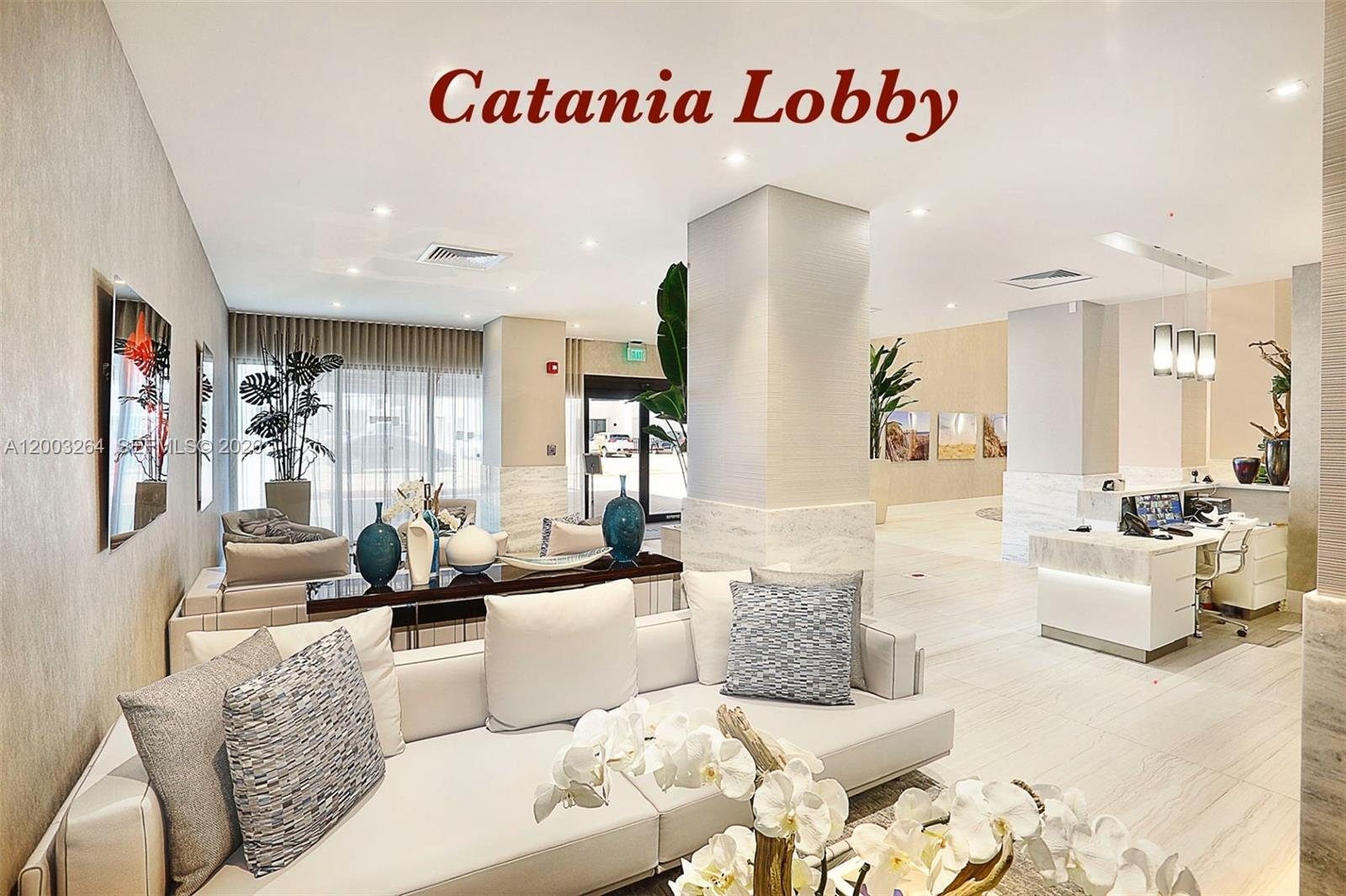 The lobby features a white sofa, a reception desk, marble accents, and decorative plants — 2301 S Ocean Dr # 1705, Hollywood FL 33019, HOLLYWOOD, FL
