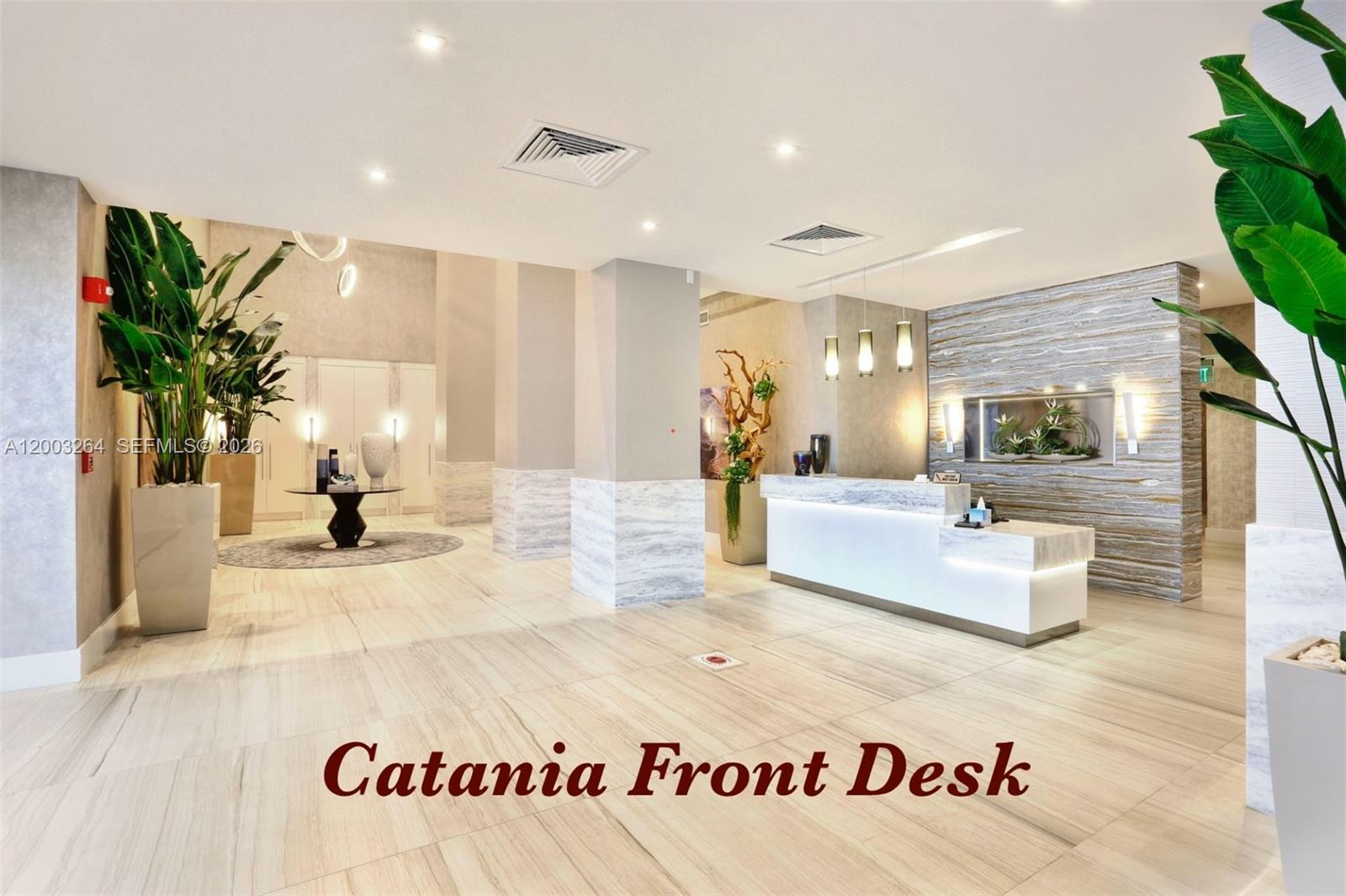 A modern lobby features a marble front desk, stone-tiled floors, and decorative indoor plants — 2301 S Ocean Dr # 1705, Hollywood FL 33019, HOLLYWOOD, FL
