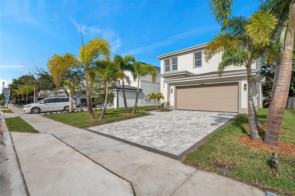 A two-story house with a paved driveway and palm trees in the front yard — 2369 BAHIA VISTA STREET, SARASOTA, FL
