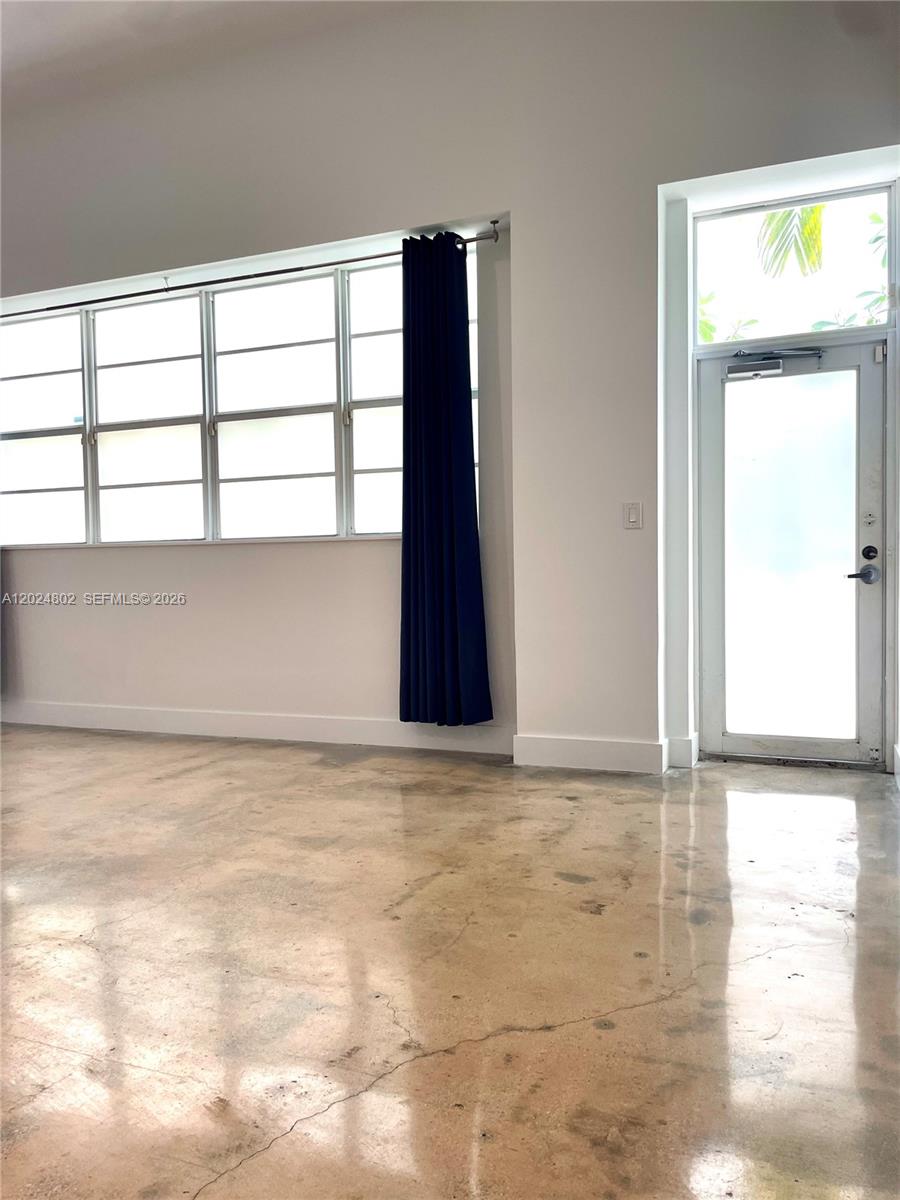 A white Art Deco building features a gated entrance and symmetrical windows behind manicured hedges — 935 Euclid Ave # 6, Miami Beach FL 33139, MIAMI BEACH, FL