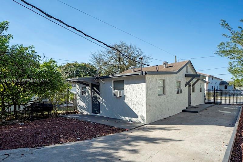 A single-story house with a white stucco exterior and a concrete driveway — 2378 NW 60th St, Miami FL 33142, MIAMI, FL