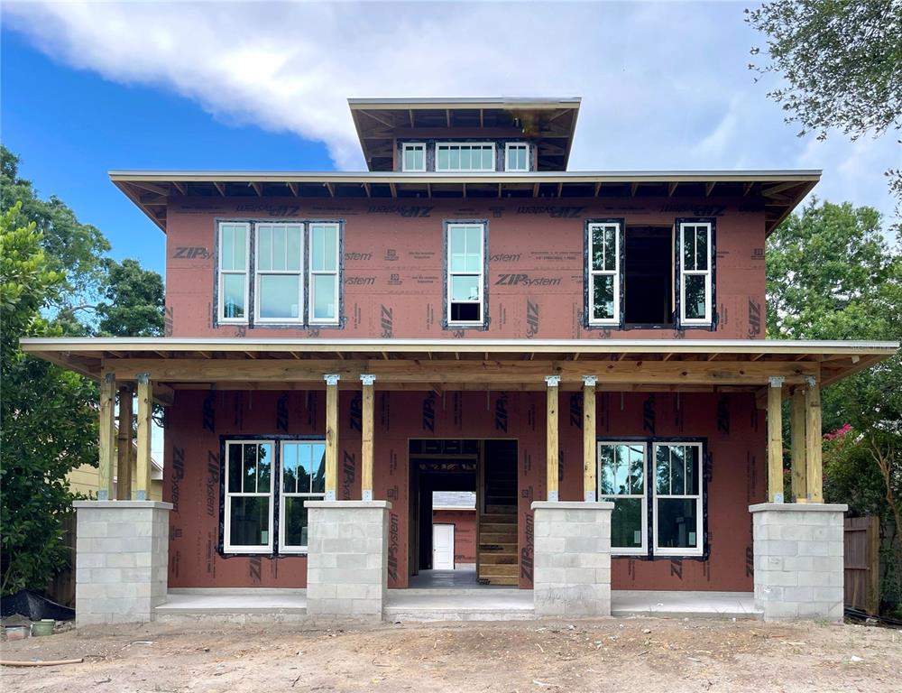 A two-story house under construction features ZIP System sheathing, a front porch, and multiple windows — 721 47TH AVENUE N, ST PETERSBURG, FL
