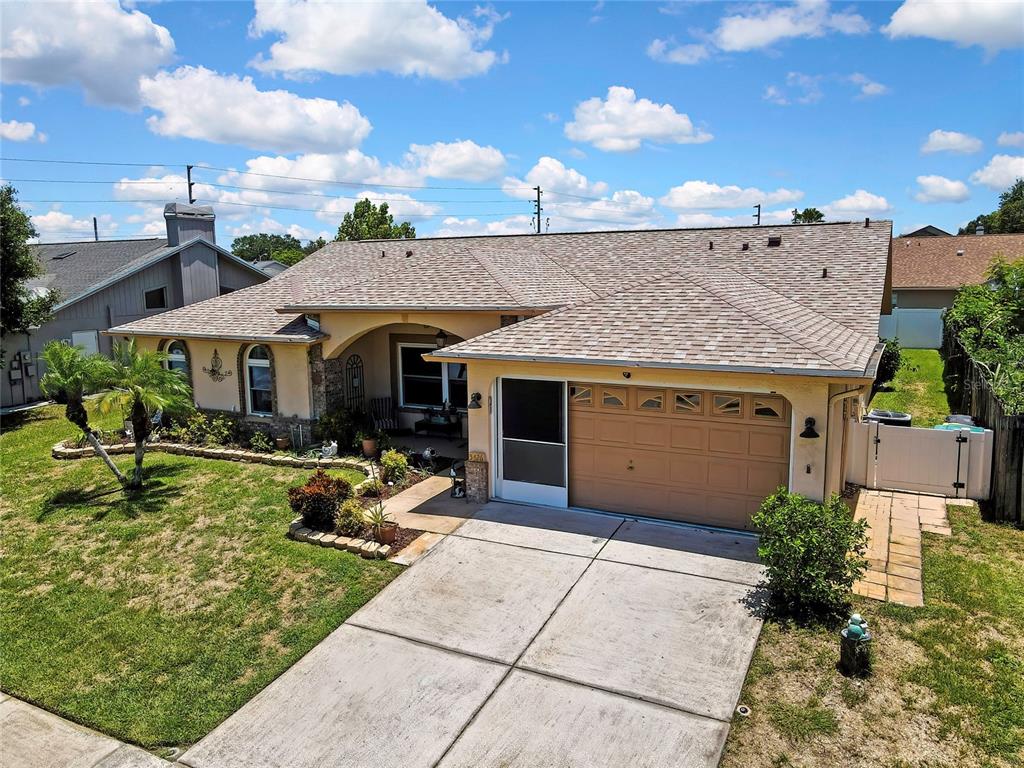An aerial view of a single-story house with a tan stucco exterior and shingled roof — 5426 LA PLATA DRIVE, NEW PORT RICHEY, FL