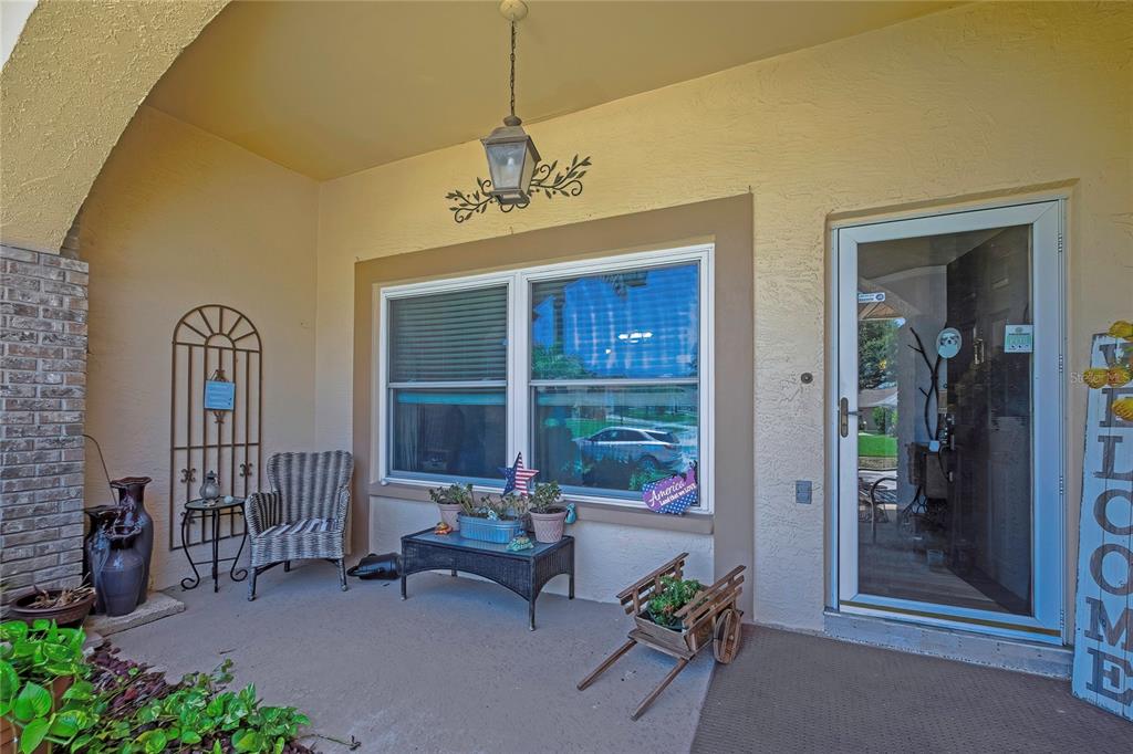 A tan single-story house features a two-car garage, a concrete driveway, and arched windows — 5426 LA PLATA DRIVE, NEW PORT RICHEY, FL