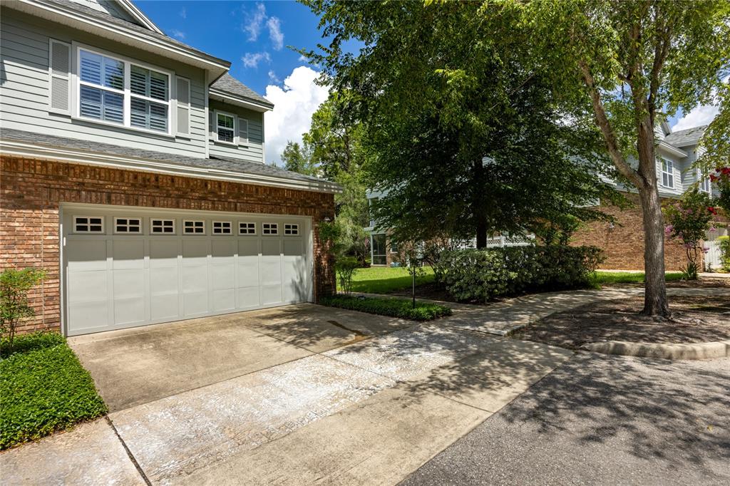 A two-story house with a brick and siding exterior features a two-car garage — 1798 NW 34TH STREET UNIT 12, GAINESVILLE, FL