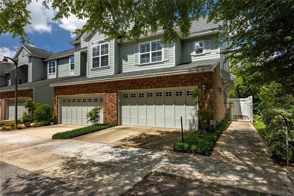 A two-story townhouse with a brick and light-colored siding exterior and a two-car garage — 1798 NW 34TH STREET UNIT 12, GAINESVILLE, FL