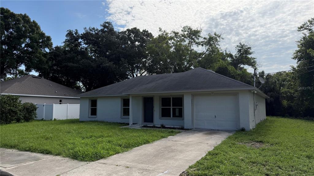 A single-story house with a white stucco exterior, a one-car garage, and a concrete driveway — 2231 WATER STREET, SANFORD, FL