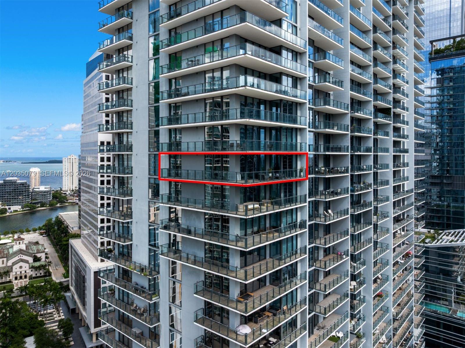 An exterior view of a high-rise residential building with a red box highlighting a balcony — 68 SE 6th St # 2612, Miami FL 33131, MIAMI, FL