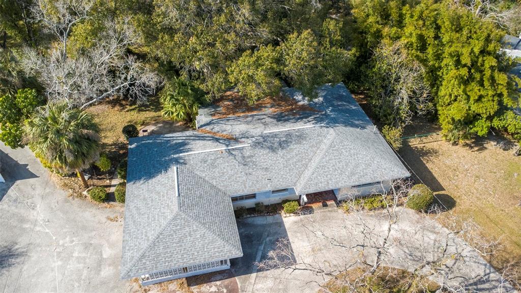 An aerial view shows a single-story house with a gray shingled roof and surrounding trees — 3306 N PERRY AVENUE, TAMPA, FL