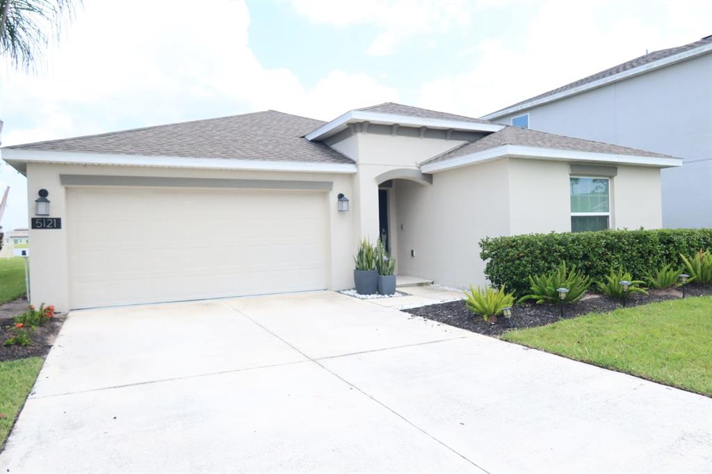 A bright entryway features light tile flooring, white walls with molding, and a glass-paneled door — 5121 FOUR STRAND COURT, ST CLOUD, FL