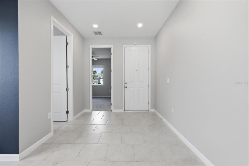A living room features a sectional sofa, two armchairs, a television, and a ceiling fan — 1037 RIVER OTTER WAY, DELAND, FL