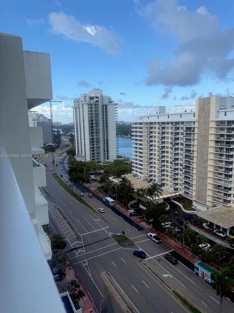 An elevated view shows a multi-lane road, high-rise residential buildings, and a waterway — 5601 Collins Ave # 1718, Miami Beach FL 33140, MIAMI BEACH, FL
