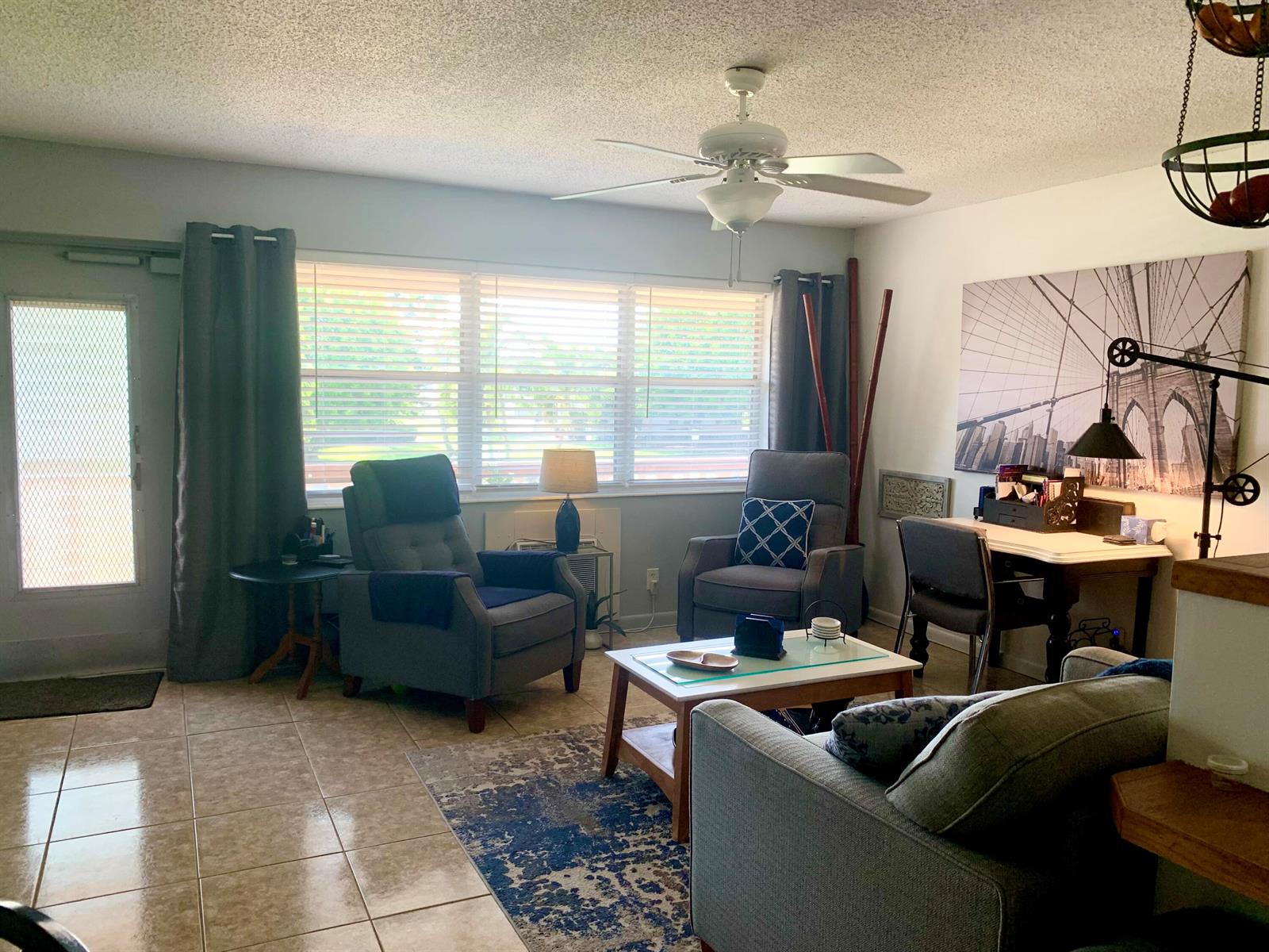 A living room features tile floors, a ceiling fan, two armchairs, and a desk area — 116 Canterbury E, West Palm Beach FL 33417, WEST PALM BEACH, FL