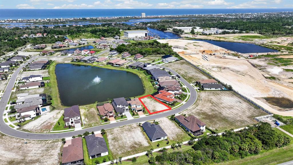 An aerial view shows a vacant residential lot outlined in red within a suburban neighborhood — 47 DEL PALMA DRIVE, PALM COAST, FL