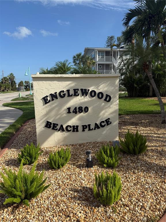 A sign for Englewood Beach Place stands in a landscaped bed with gravel and shrubs — 1480 GULF BOULEVARD UNIT 304, ENGLEWOOD, FL