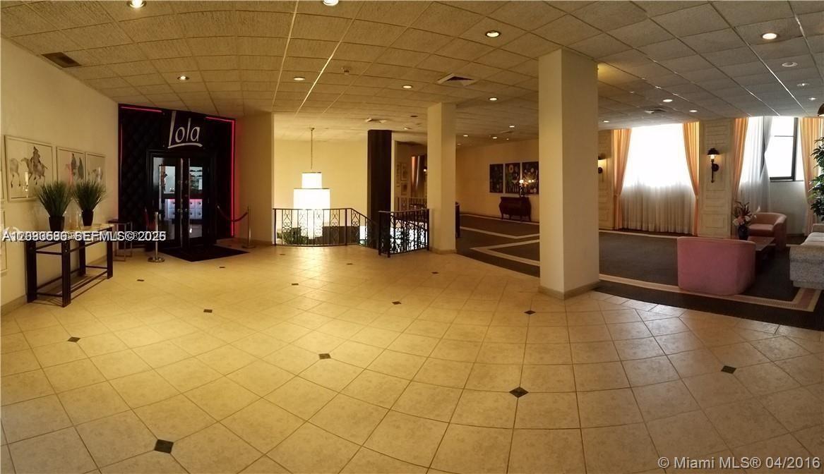 A spacious lobby features tiled floors, a recessed seating area, and a doorway labeled Lola — 5555 Collins ave # 9V, Miami Beach FL 33140, MIAMI BEACH, FL