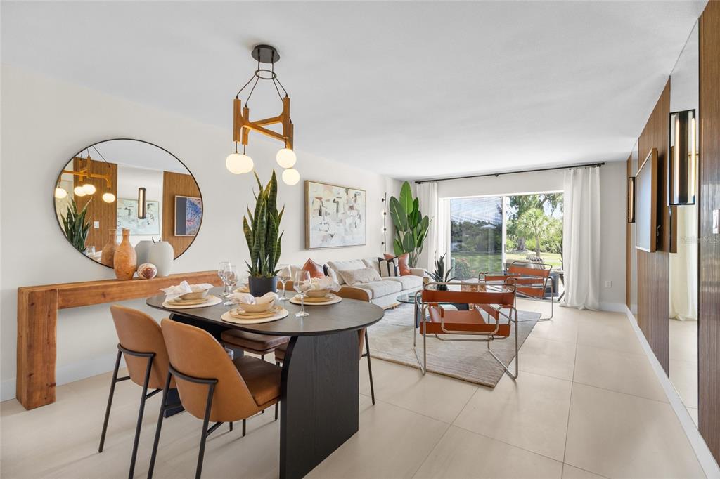 A living room and dining area featuring orange leather chairs, wood paneling, and mirrored walls — 3330 GULF OF MEXICO DRIVE UNIT 107D, LONGBOAT KEY, FL