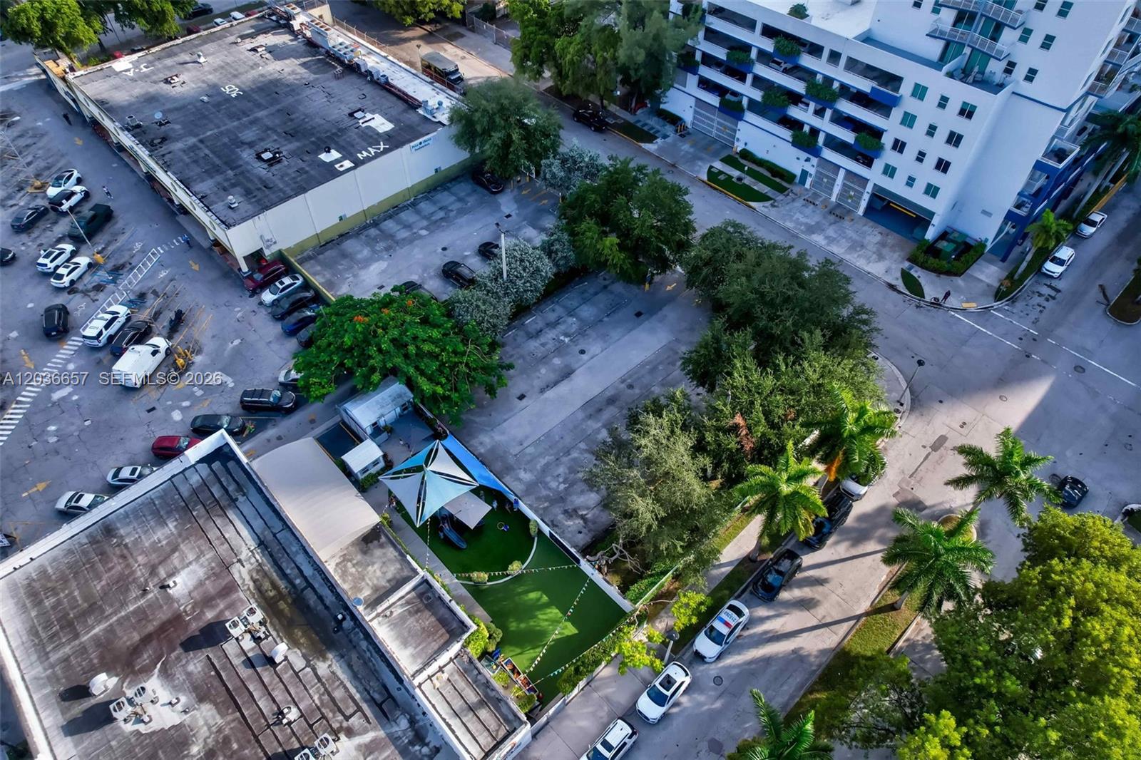 An aerial view shows a parking lot, a small green space with a canopy, and buildings — 275 NE 18th St, Miami FL 33132, MIAMI, FL