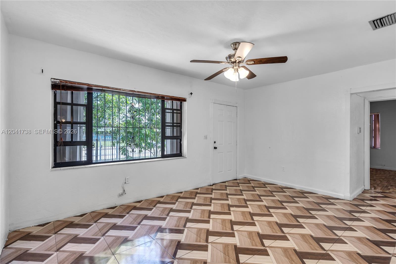 A room with white walls, a ceiling fan, and patterned tile flooring — 576 NW 147th St, Miami FL 33168, MIAMI, FL