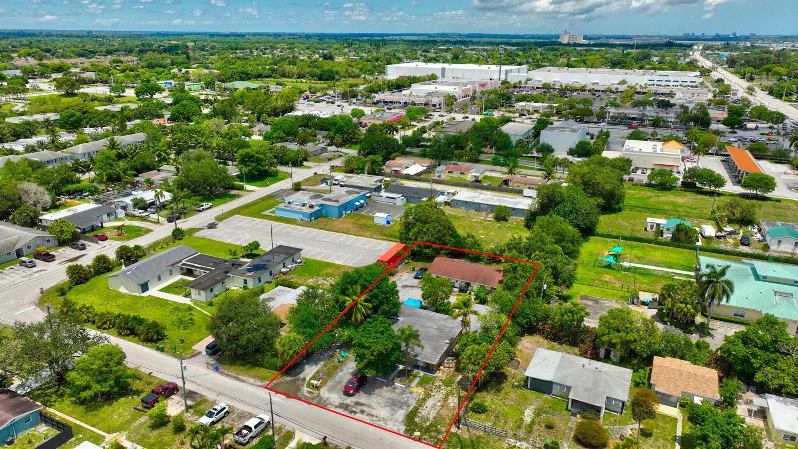An aerial view shows a residential property outlined in red with two buildings and trees — 3063 Floweva Street # A, West Palm Beach FL 33406, WEST PALM BEACH, FL