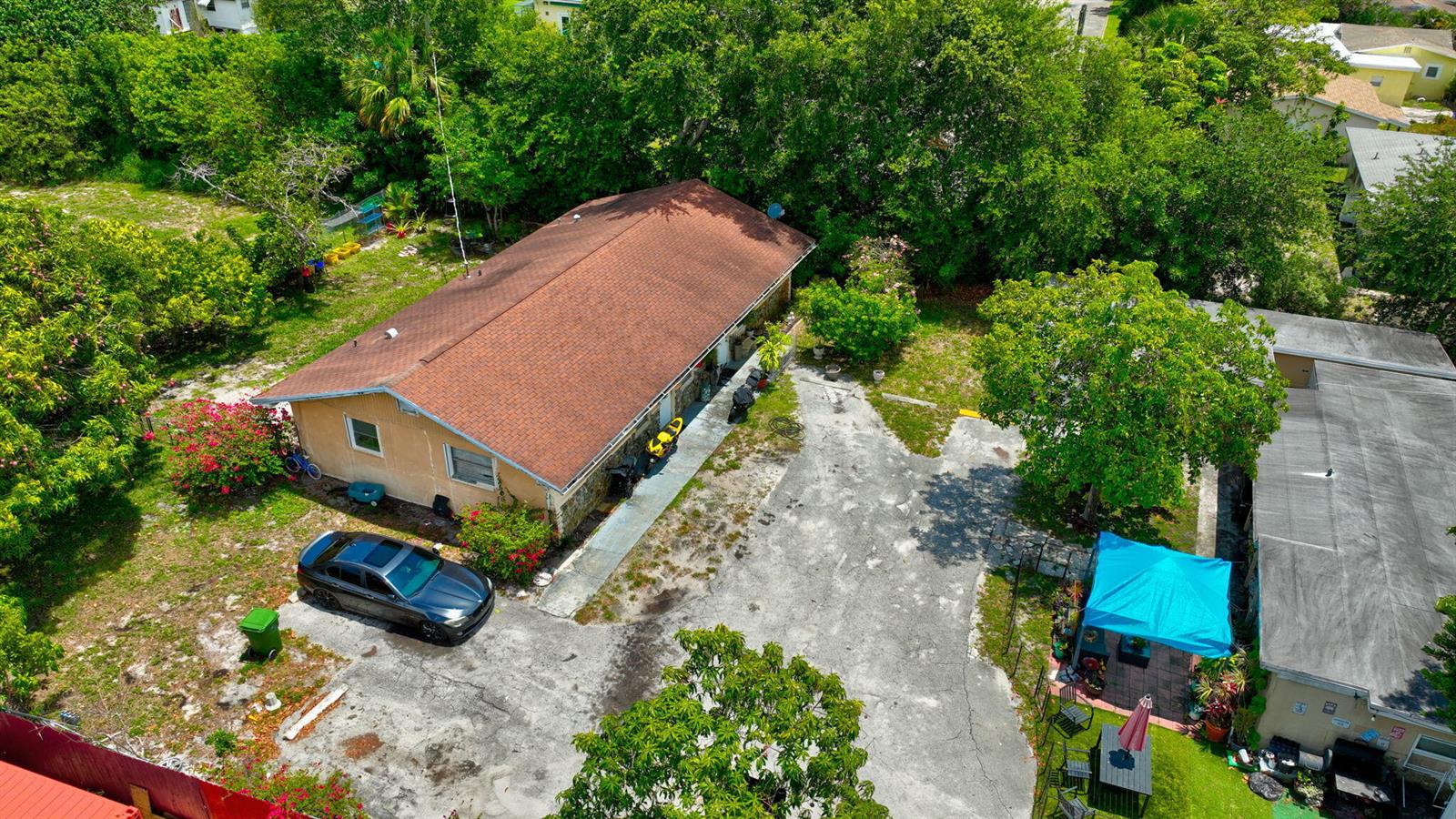 An aerial view shows a house with a brown roof, a driveway, and a blue canopy — 3063 Floweva Street # A, West Palm Beach FL 33406, WEST PALM BEACH, FL