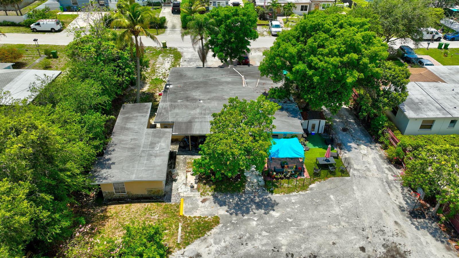 An aerial view shows a single-story house with a flat roof and a backyard patio — 3063 Floweva Street # A, West Palm Beach FL 33406, WEST PALM BEACH, FL