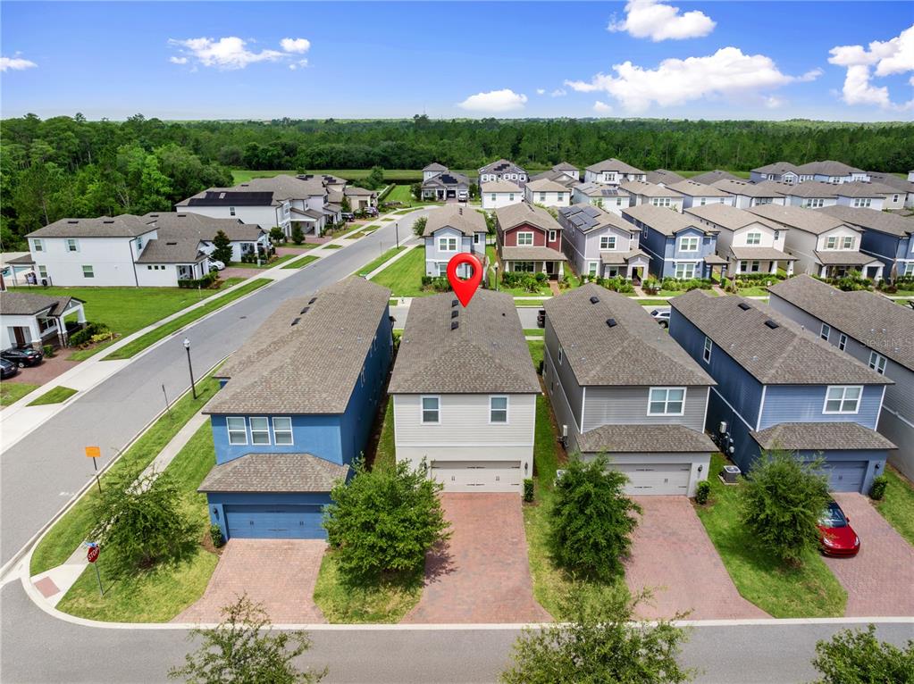 An aerial view shows a row of suburban houses with a red pin on one — 12597 ENCORE AT OVATION WAY, WINTER GARDEN, FL