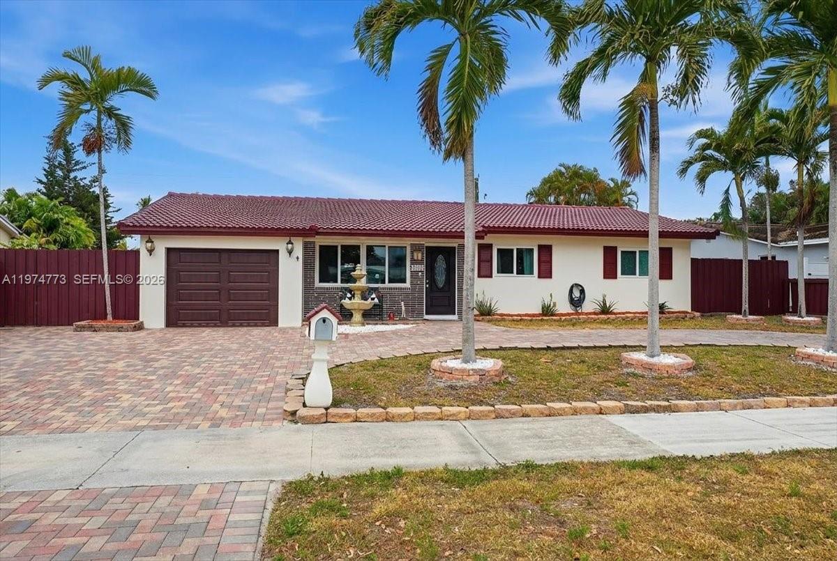 A single-story house with a red tile roof, brick accents, and a paved driveway — 4925 Tyler St, Hollywood FL 33021, HOLLYWOOD, FL