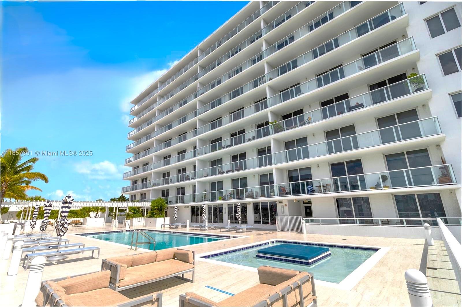 A multi-story apartment building with balconies overlooks a swimming pool and a hot tub — 4250 Biscayne Blvd # 1008, Miami FL 33137, MIAMI, FL