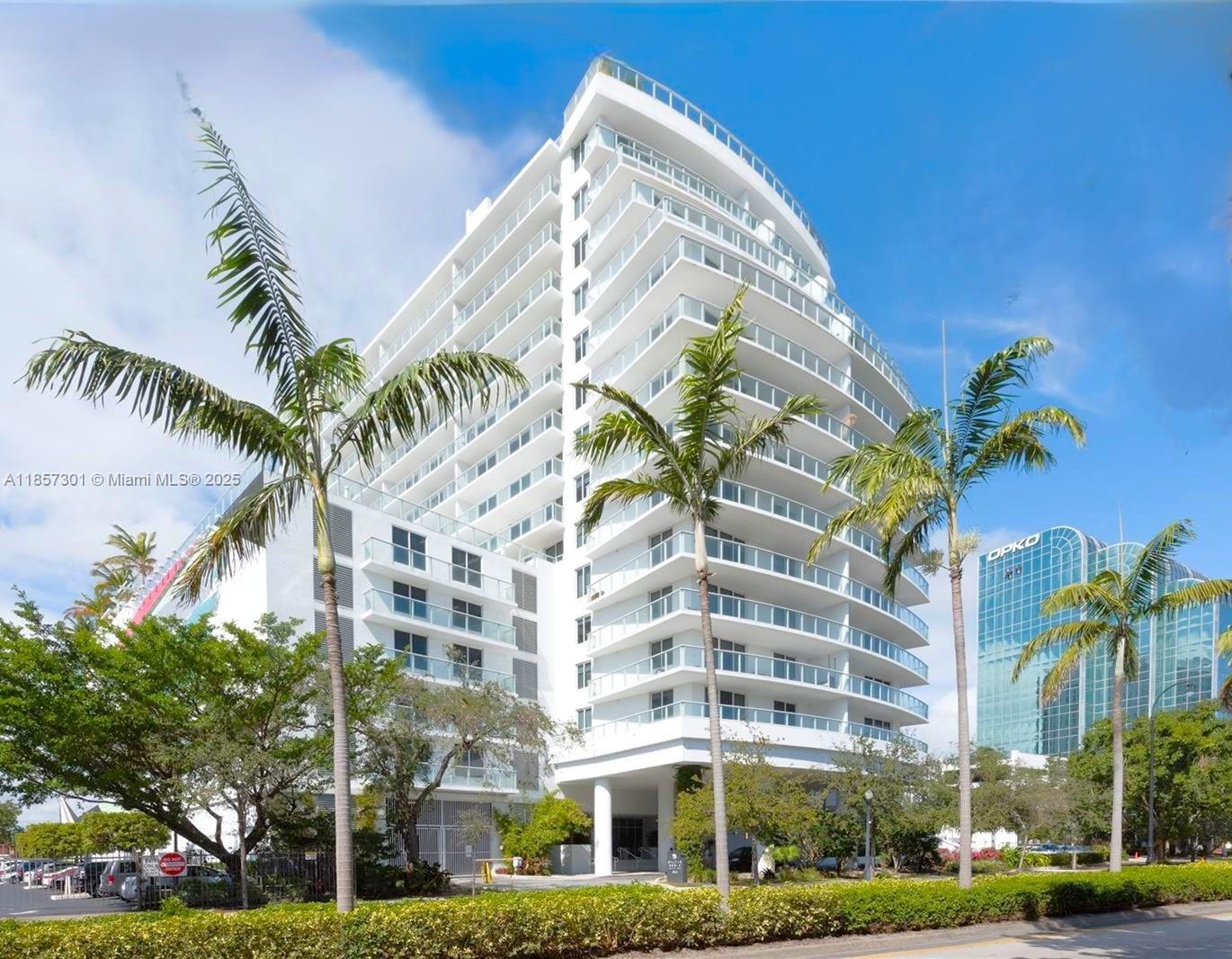 A multi-story white residential building with curved balconies stands next to a glass office tower — 4250 Biscayne Blvd # 1008, Miami FL 33137, MIAMI, FL