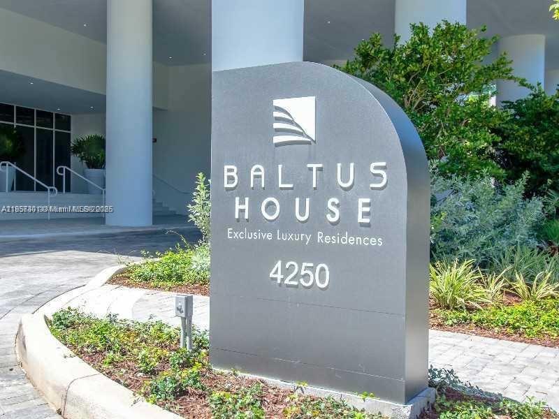 A gray monument sign for Baltus House stands in front of a modern building entrance — 4250 Biscayne Blvd # 1008, Miami FL 33137, MIAMI, FL