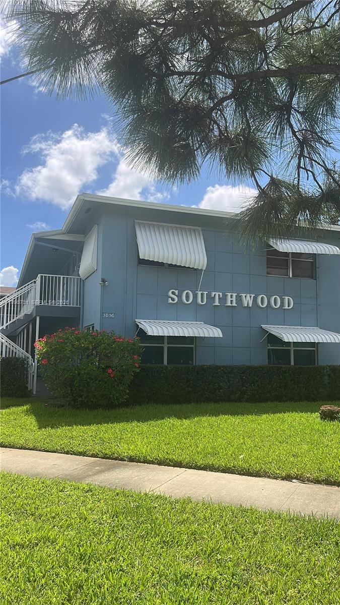 A two-story blue apartment building features white metal awnings and a white exterior staircase — 3856 S Cir Dr # 6, Hollywood FL 33021, HOLLYWOOD, FL