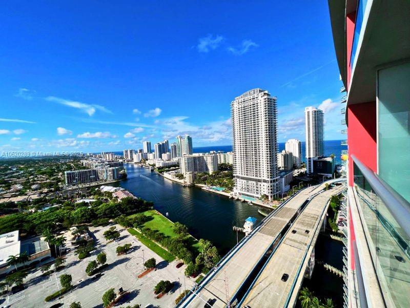 An elevated outdoor view shows a waterway, city skyline, and a highway bridge — 2602 E Hallandale Beach # 2008A, Hallandale Beach FL 33009, HALLANDALE BEACH, FL