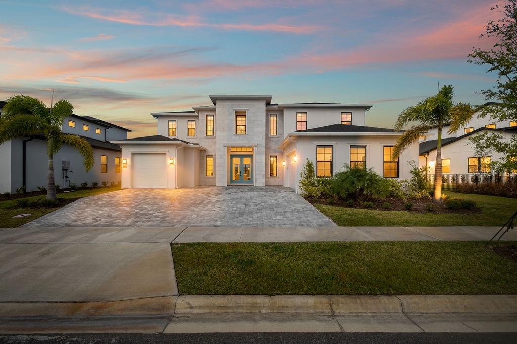 An aerial view shows a two-story white house with a gray roof and paved driveway — 9453 GOLDEN LAUREL LANE, ORLANDO, FL