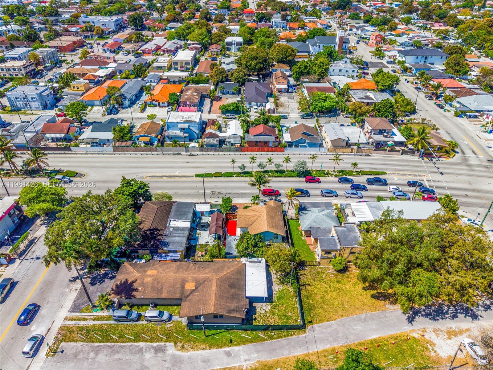 An aerial view shows a residential neighborhood with houses, streets, and a multi-lane road — 1675 NW 2nd St, Miami FL 33125, MIAMI, FL