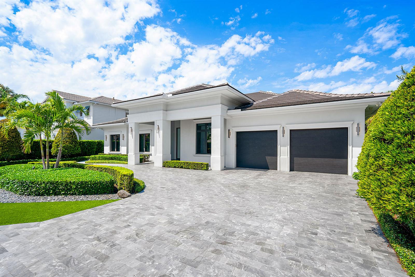 A modern white single-story house with a gray tiled driveway and two dark garage doors — 2351 Cherry Palm Road, Boca Raton FL 33432, BOCA RATON, FL
