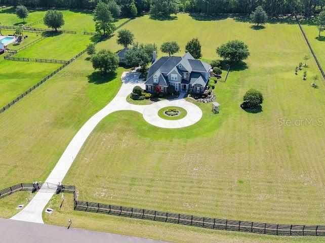 An aerial view shows a large house with a circular driveway on a grassy lot — 10401 NW 153RD TERRACE, ALACHUA, FL