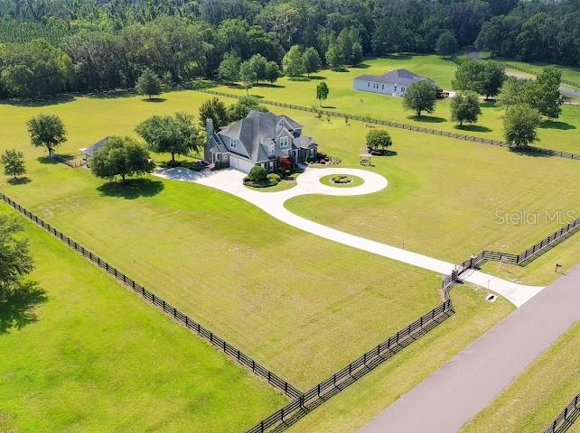 An aerial view shows a large house with a circular driveway on a grassy lot — 10401 NW 153RD TERRACE, ALACHUA, FL