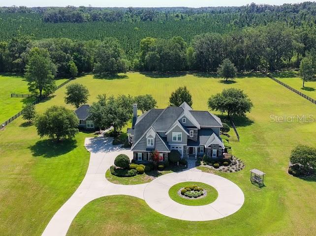 An aerial view shows a large house with a circular driveway on a grassy lot — 10401 NW 153RD TERRACE, ALACHUA, FL