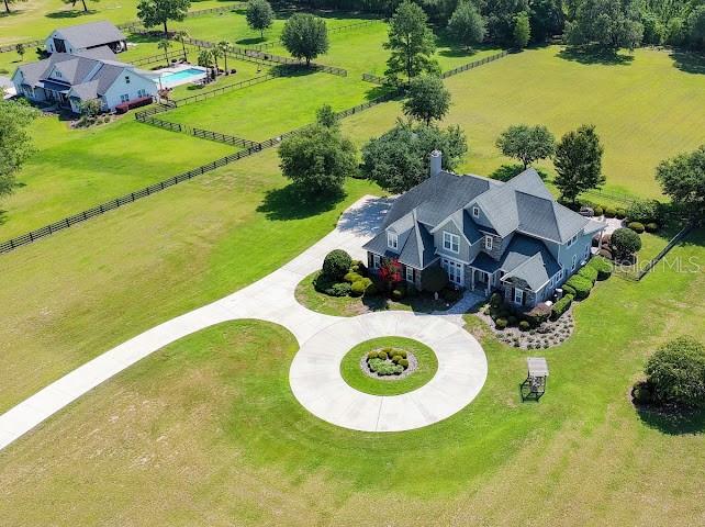 An aerial view shows a large house with a circular driveway on a grassy lot — 10401 NW 153RD TERRACE, ALACHUA, FL