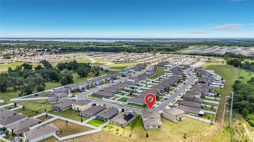 An aerial view shows a suburban neighborhood with a red location pin on a house — 2739 RED EGRET DRIVE, BARTOW, FL