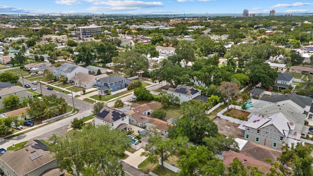 An aerial view shows a suburban neighborhood with houses, trees, and a construction site — 214 N HABANA AVENUE, TAMPA, FL