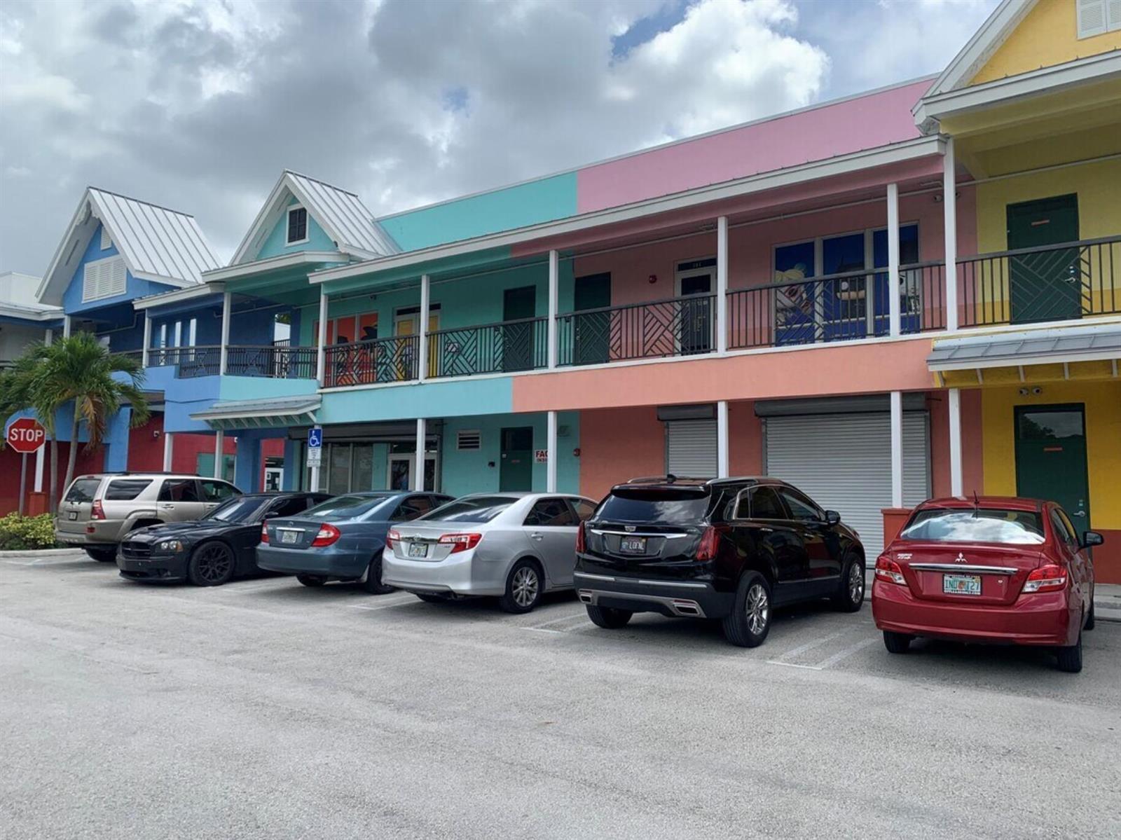A multi-story commercial building with colorful facades and a parking lot in front — 2349 N State Road 7, Lauderhill FL 33313, LAUDERHILL, FL