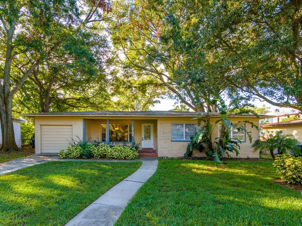 A single-story house with a beige brick exterior, a front porch, and a one-car garage — 3136 W EUCLID AVENUE, TAMPA, FL