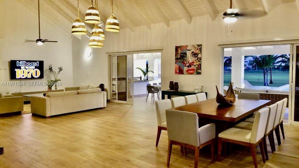 A spacious open-concept living and dining area features light wood floors and vaulted ceilings — Samanes, La Estancia Golf & Country Club, DR, DR