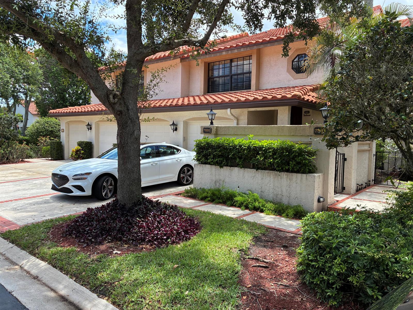 A white sedan is parked in the driveway of a two-story house with a tiled roof — 7895 La Mirada Drive, Boca Raton FL 33433, BOCA RATON, FL